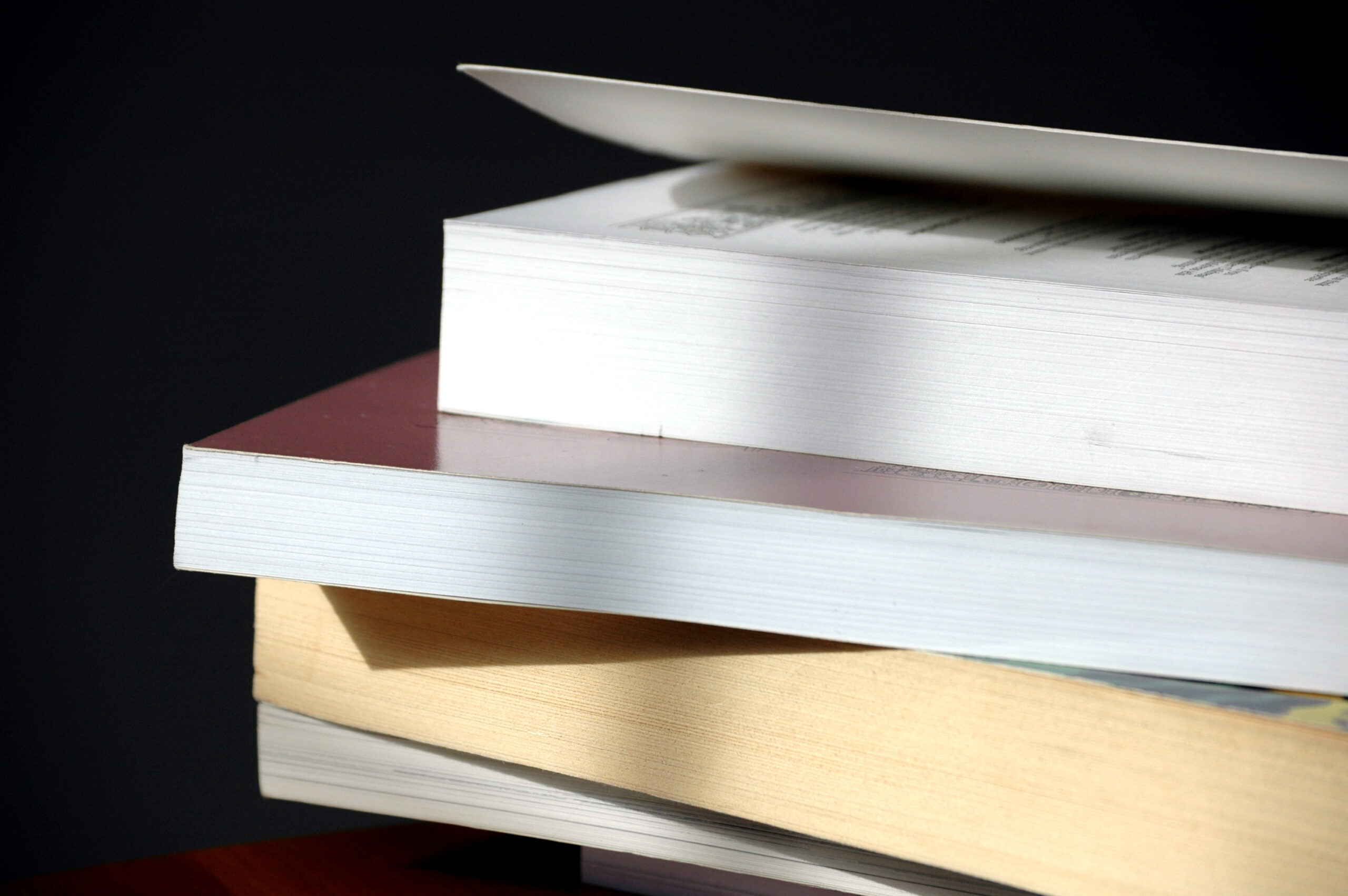 close up on the fore edges of a stack of books